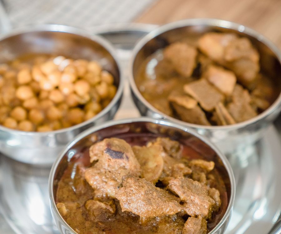 Steel bowls of curry on a tray (illustrative stock photo)
